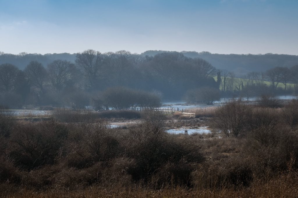 Three Bridges, Combe Valley in flood on winters morning